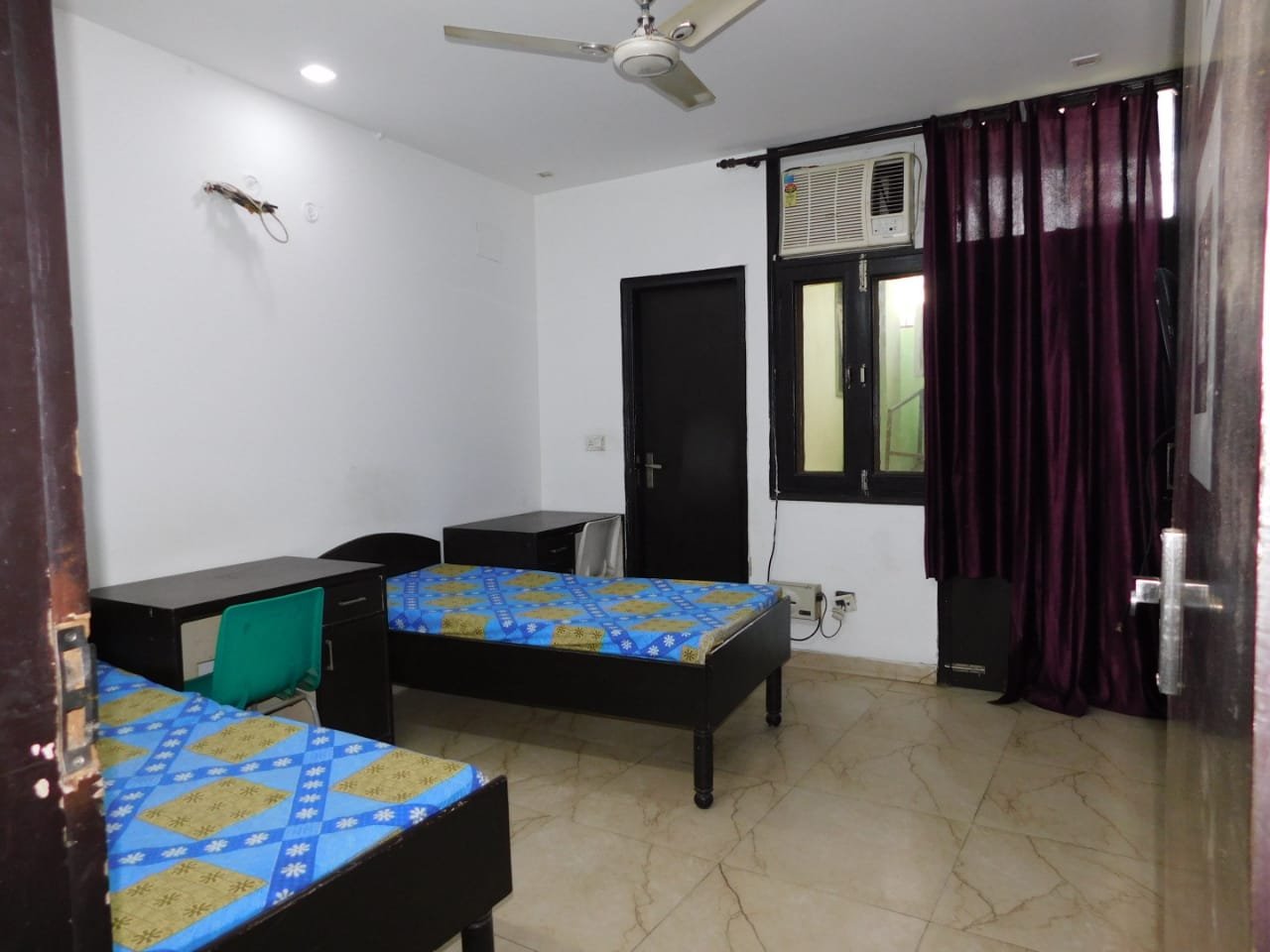 Furnished twin-sharing room at Pathshala Homes